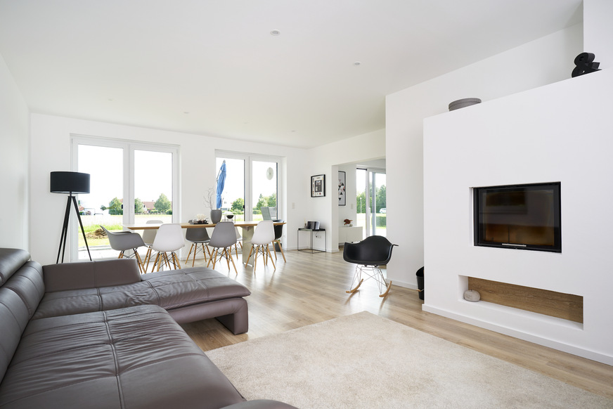 Bright colours and floor-to-ceiling windows make the living room look open and friendly.