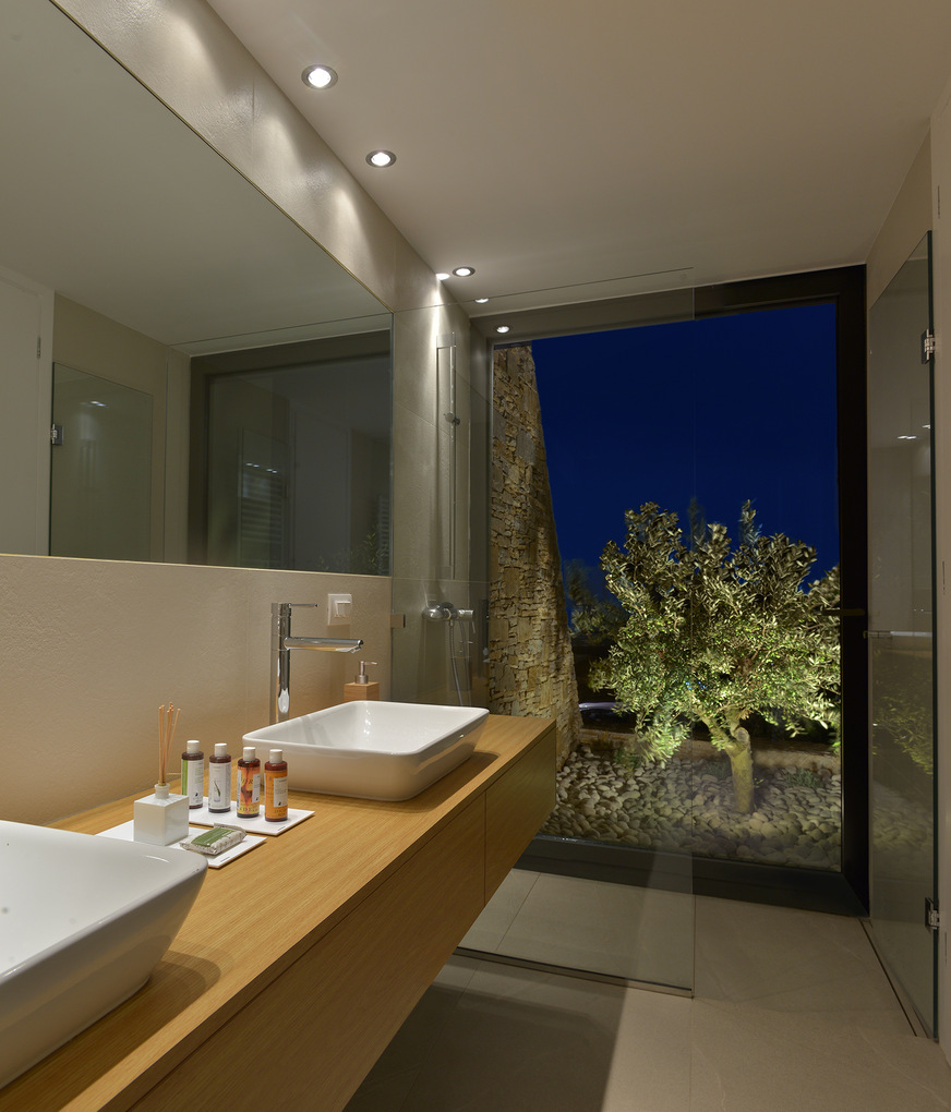 The bathroom looks out onto the nearby olive groves.