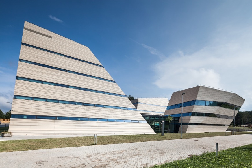 The horizontal elements of the facade seem to evoke a stack of books, with the rows of windows as the covers.