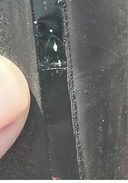 The crack runs horizontally into the glass edge at an angle of 90 degrees.