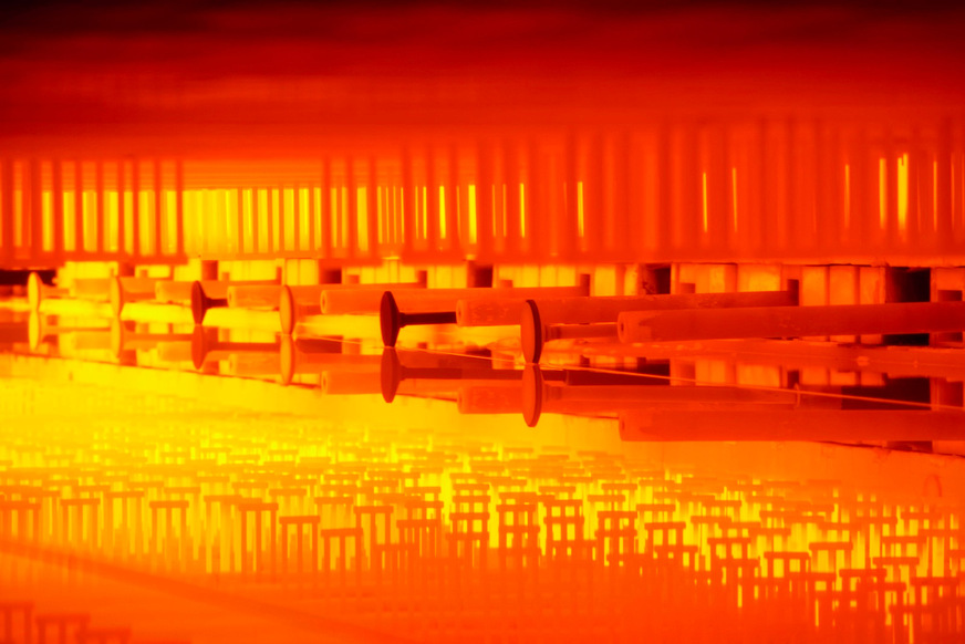 View inside the float bed, where the viscous molten glass floats on liquid tin.