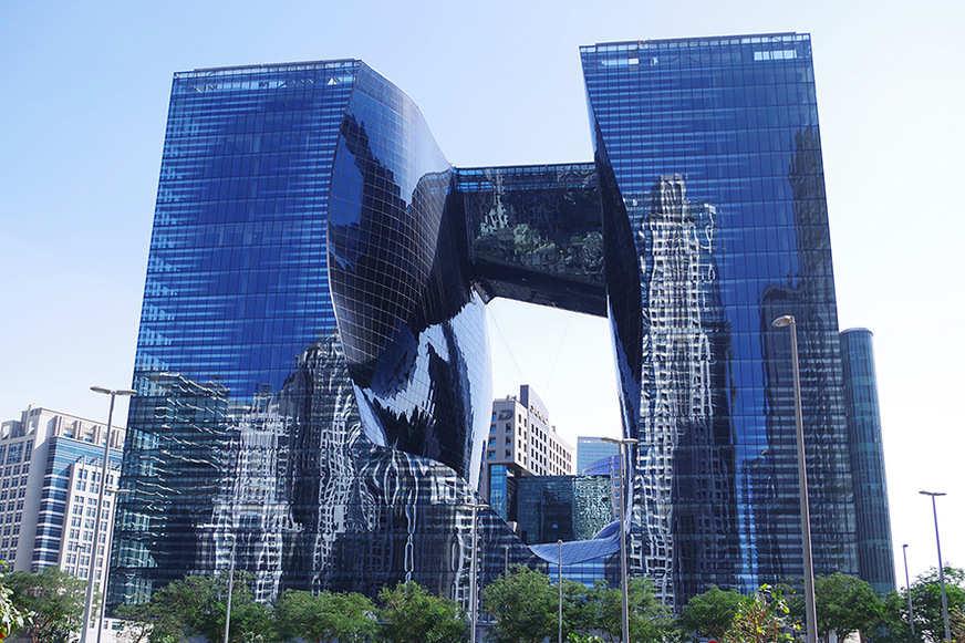 Some 6,000 square metres of curved, tinted glass provide
