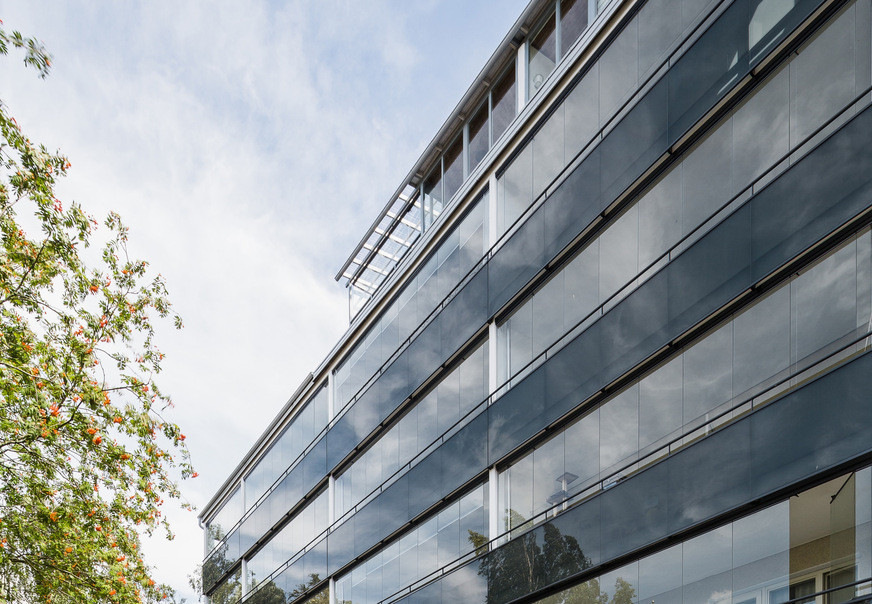 The glazing of the balconies enhances the appearance of the renovated building.