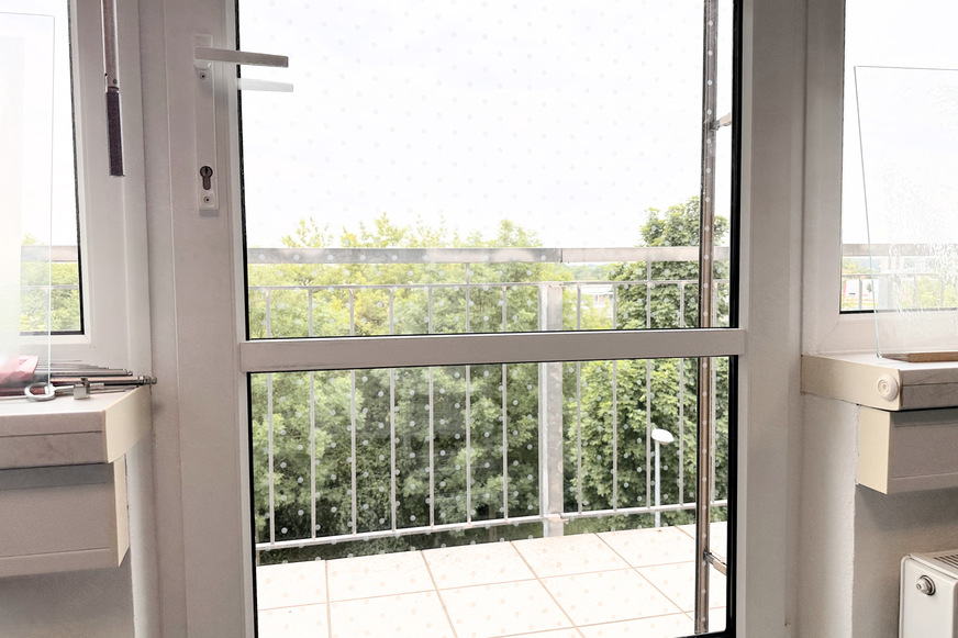 Here is a balcony door that has been retrofitted with bird protection using laser technology.