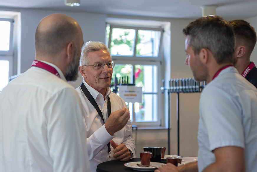 Gottfried Brunbauer (centre), CEO of Lisec, in conversation with participants.