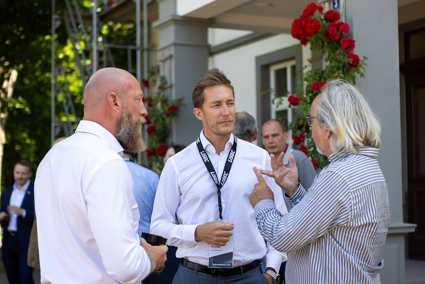 CFO Oliver Pichler (centre) talking to visitors.