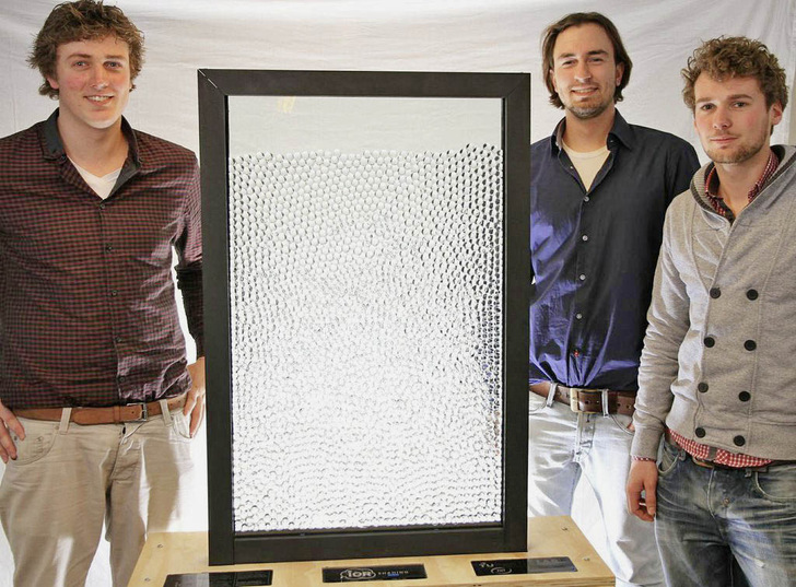 Proud students presenting their functional prototype of the IOR shading system. When no shading is required, the transparent spheres are immersed in a liquid with the exact same refractive index and so become invisible. - © Bucky Lab / TU Delft
