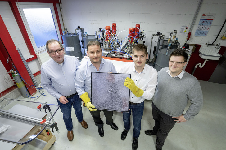 Proudly presenting the result of a bullet test of one of the new laminated glass elements (from left to right): Company owner Eberhard Scheidel, Christian Scherer (H.B. Fuller | Kömmerling), son Moritz Scheidel and Benjamin Gantner (H.B. Fuller | Kömmerling). - © Wolfram Scheible / HB Fuller

