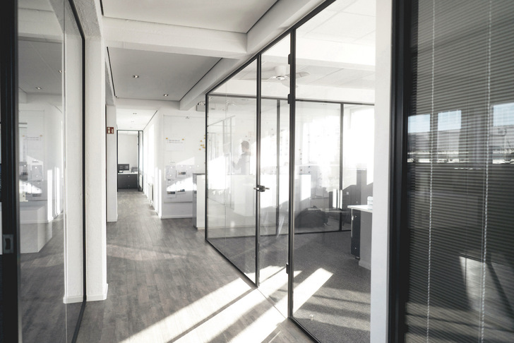 Glass partition walls are often used in offices.
