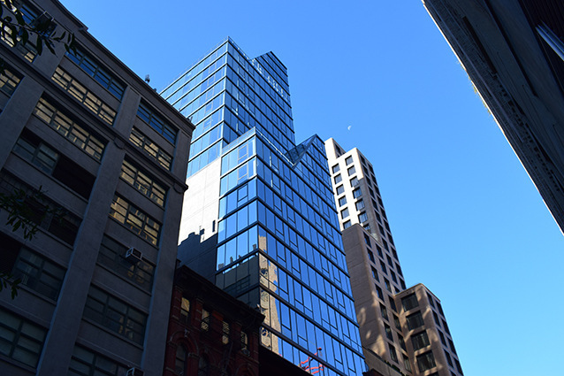 In New York's Manhattan borough, a large glazed tower directly above a historic building creates new living space.