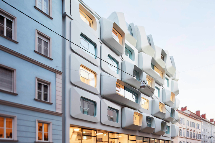 The 43 Argos eyes of different sizes and orientated in different directions are distributed over five storeys. The whole is supported by a two-storey glazed plinth.