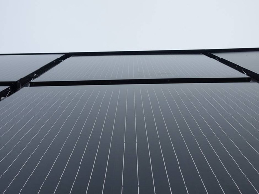 Close-up of the installed photovoltaic elements. They replace the thermal insulation of a facade.
